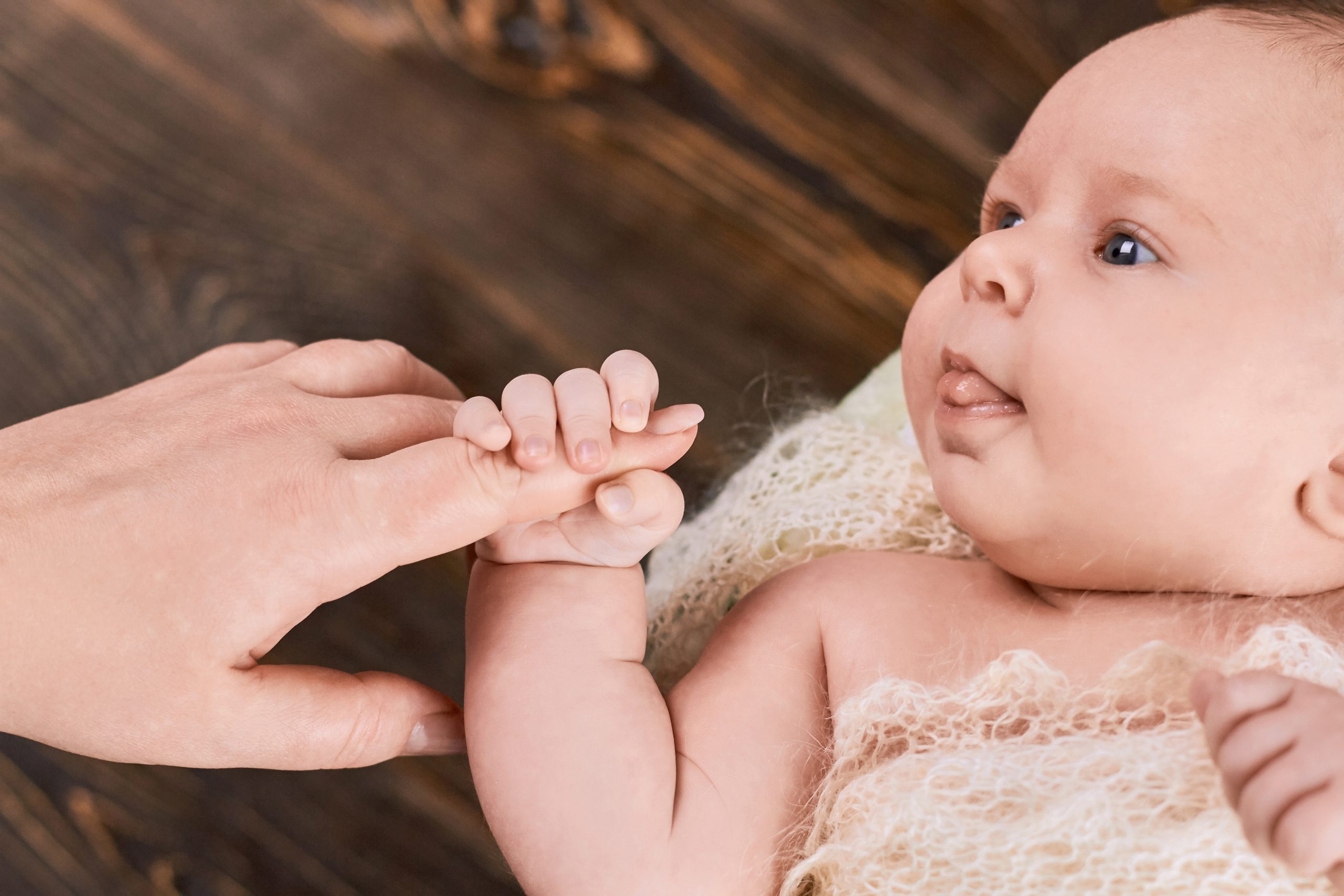 Baby,Holding,Finger,Of,Woman.,Caucasian,Child,Close,Up.,What