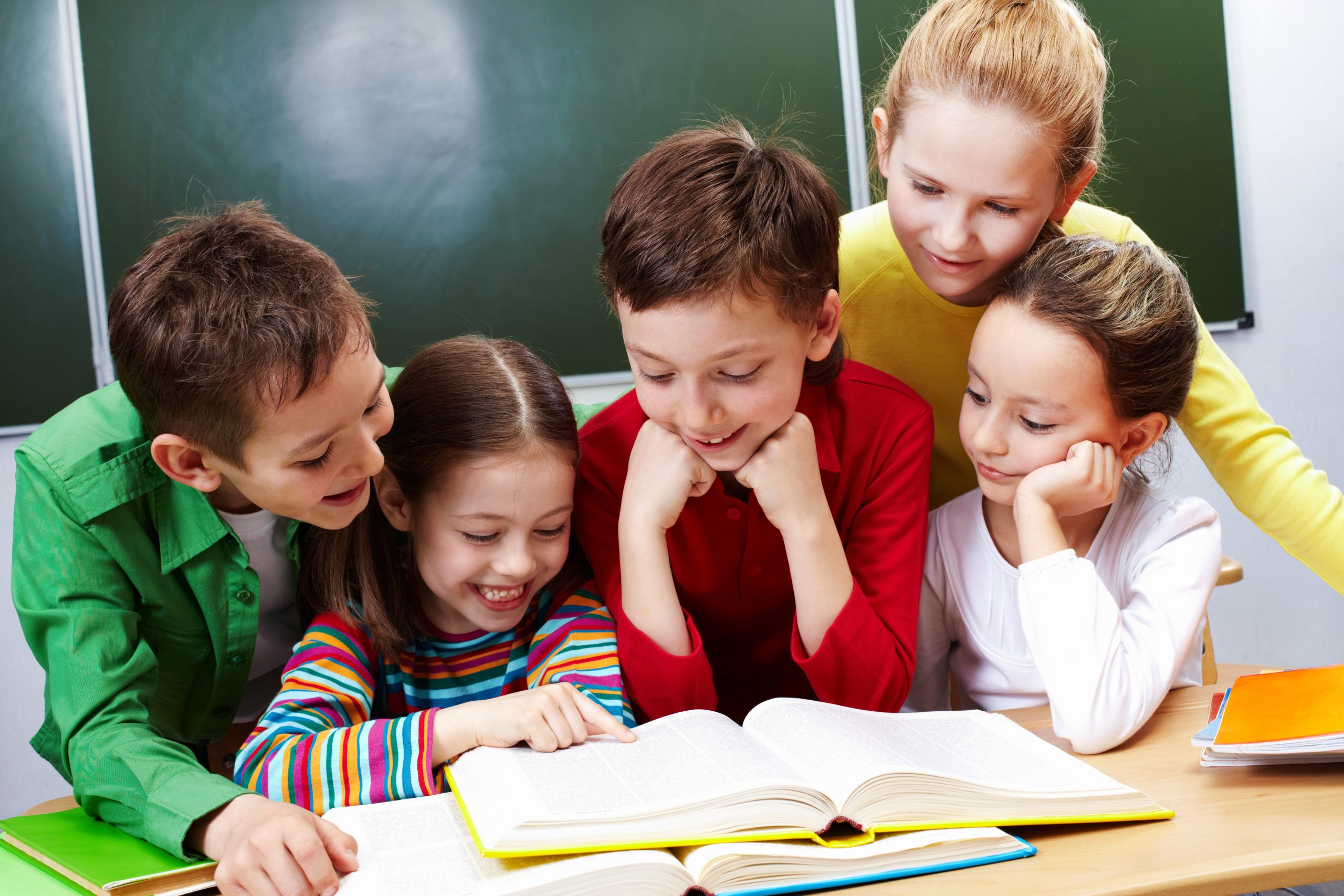 Portrait,Of,Friendly,Group,Reading,Book,In,Classroom