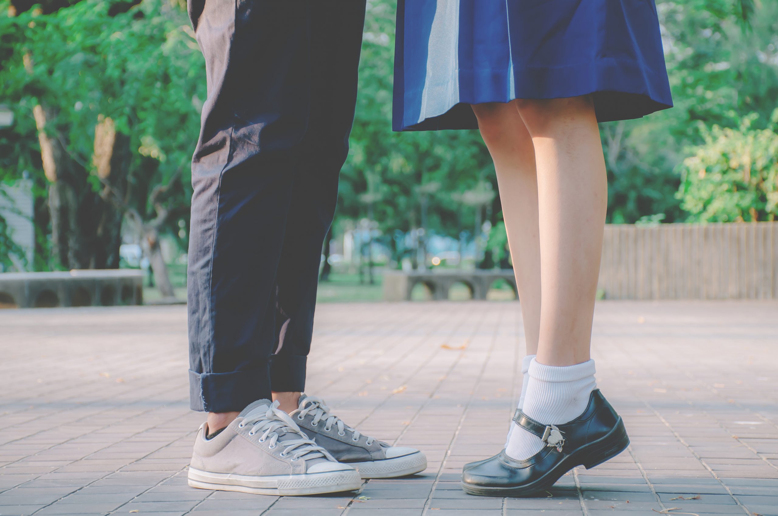 Closeup,Legs,And,Sneakers,Of,Couple,In,School,Uniform,Standing