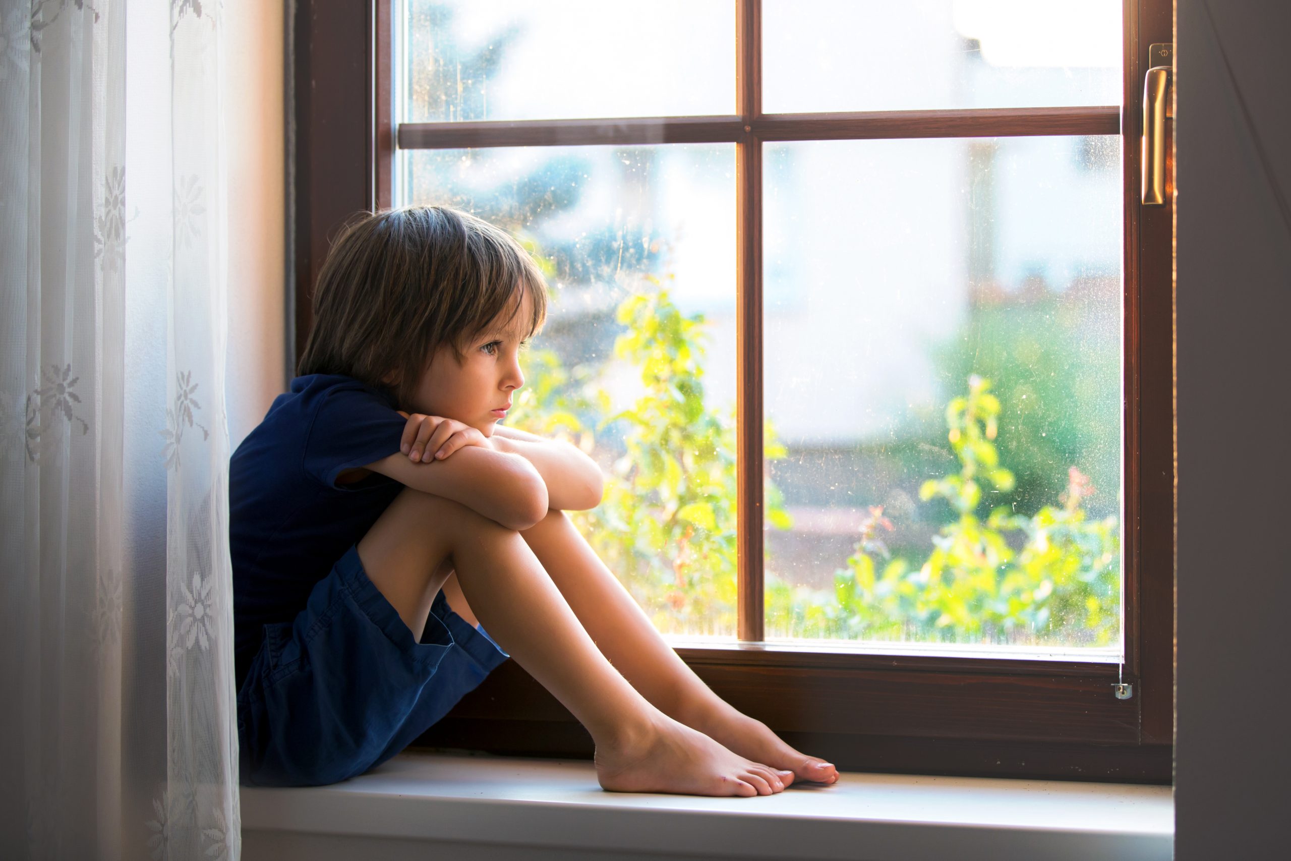 Sad,Child,,Boy,,Sitting,On,A,Window,Shield,,Watching,The