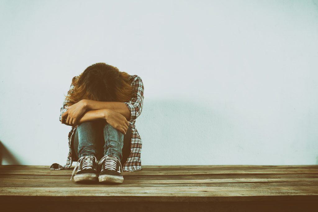 Sad woman hug her knee,nobody bully