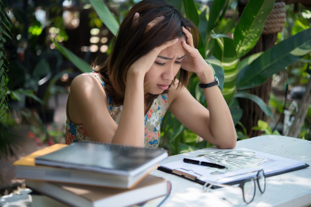 Women with stress hands on head while thinking with new project วิกฤตทักษะที่รัฐบาลต้องเร่งแก้ไข