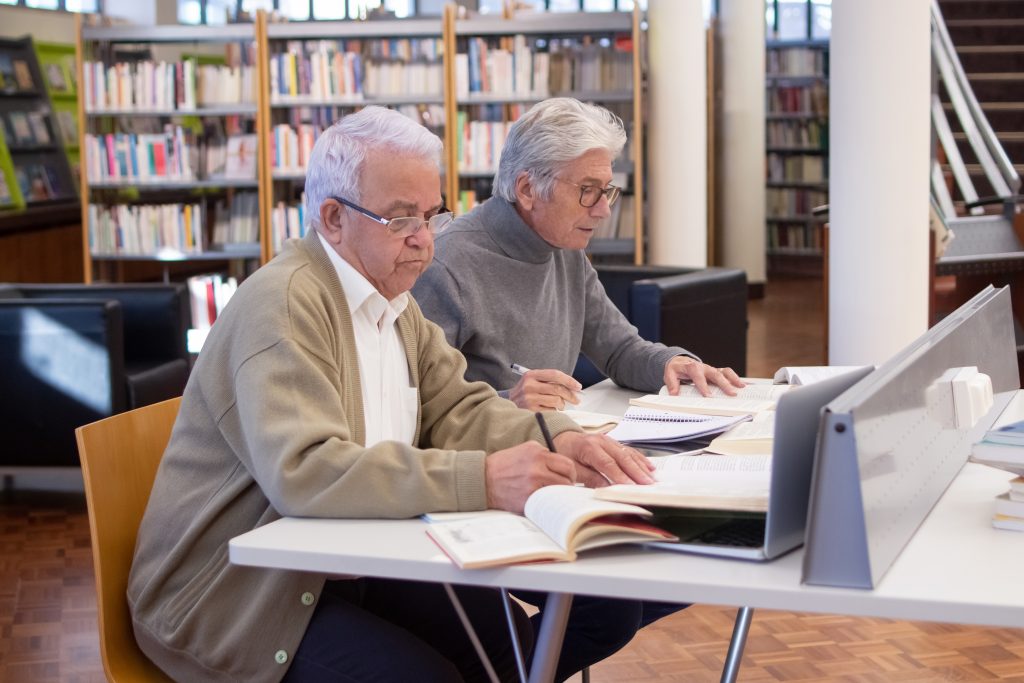 Side view of aged men actively studying ผู้สูงอายุ
