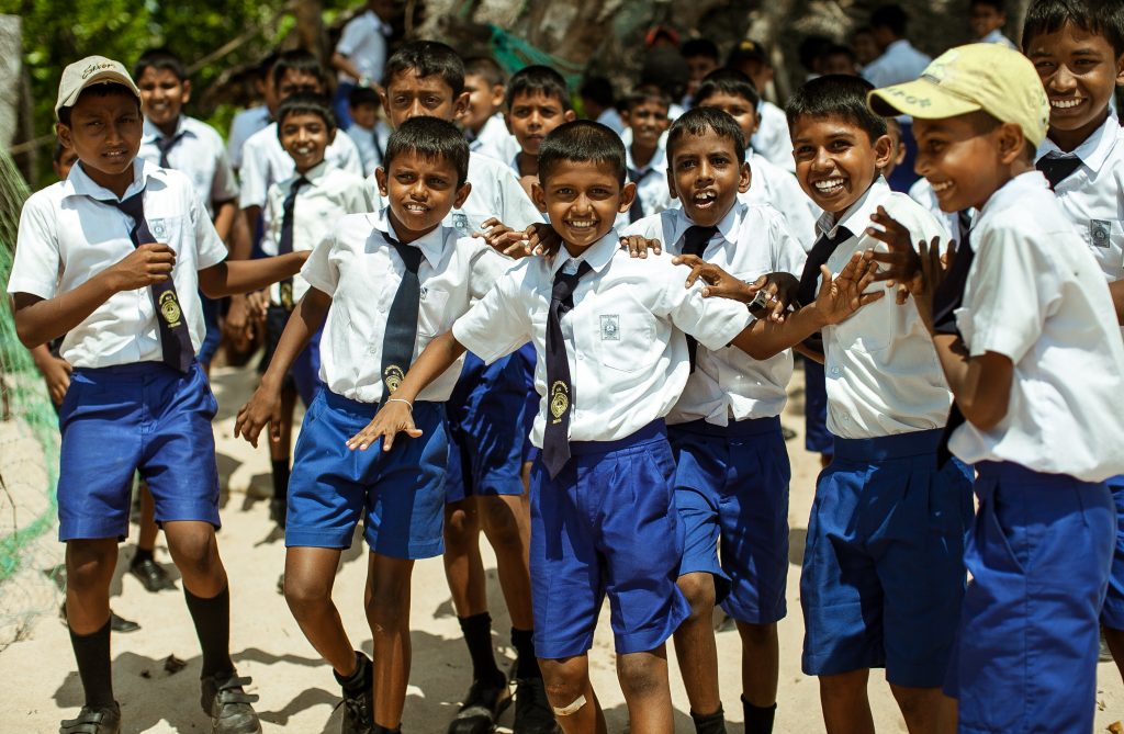 School children dressed in uniform have fun and play in the schoolyard. Wadduwa, Sri-Lanka. เด็กอินเดีย